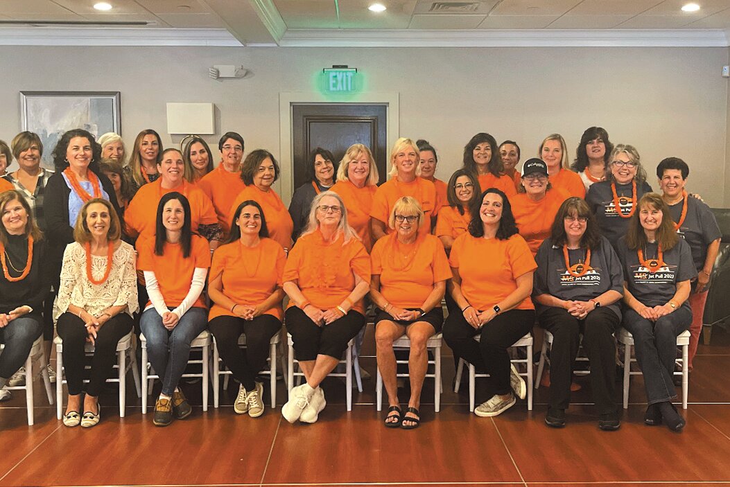 PULLING FOR JOAN: The Wilkinson Warriors (wearing orange t-shirts) and those who had planned to cheer Joan Wilkinson and the team at Saturday’s jet pull gather for a photo at Chelo’s.
